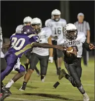  ?? Michael Orrell/News-Times ?? Heading for the end zone: Smackover's Austin Goodwin slips past Junction City's Deandre Malone on his way to score in the first half of junior high action at Junction City on Thursday. The Bucks beat the Dragons 20-0.