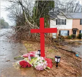  ?? AJC 2023 ?? A memorial for University of Georgia football player Devin Willock and staff member Chandler Lecroy remains at the site where their automobile crashed on Barnet Shoals Road on Jan. 19 in Athens. Willock and Lecroy died from their injures.