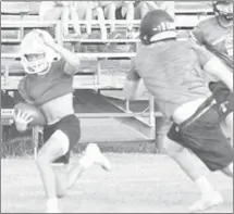  ??  ?? A Palestine-Wheatley player catches a pass before being wrapped up by a McCrory defender in Tuesday's 7-on-7 events at Patriot Field.