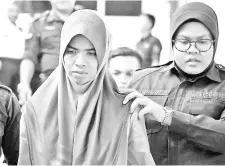  ??  ?? Housewife Asmani Mat (left) was charged with murdering her youngest son aged 19 months at Felda Jengka 13, Maran on Sunday. - Bernama photo