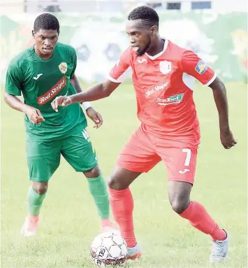  ??  ?? Jamiel Hardware (right) in action for Boys’ Town against Humble Lion’s Ricardo Dennis in the Red Stripe Premier League earlier this season.