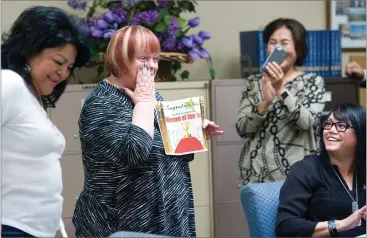  ?? RECORDER PHOTOS BY CHIEKO HARA ?? Cheryl Cook, second left, reacts when she opened the envelope Tuesday at the Lindsay Chamber of Commerce office in Lindsay. Cook was named 2017 Woman of the Year, by the chamber.