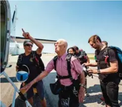  ??  ?? Scotty Freeland, left, offers advice to Wendell Ashcroft about watching his head when he climbs into the plane.