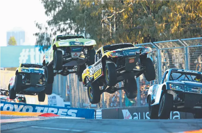  ?? Picture: DAVID CLARK ?? Getting airborne is the signature move of Stadium Super trucks and Gold Coaster Matt Brabham took that to the extreme yesterday by landing on winner PJ Jones in a charge at the line.