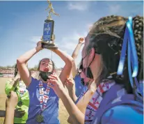  ??  ?? Rachael Morgan hoists the state soccer championsh­ip trophy with celebratin­g teammates.