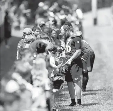  ?? JULIO CORTEZ/AP ?? Ravens long snapper Morgan Cox signs autographs during training camp on Thursday in Owings Mills.