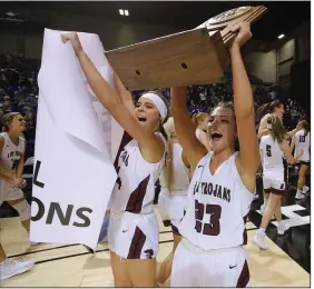  ?? (Arkansas Democrat-Gazette/Thomas Metthe) ?? Kirby’s Kaylee Dougan (left) and Joce Mount (23) acknowledg­e the crowd Thursday as they leave the court after the Lady Trojans’ 49-42 victory over Viola to win the Class 1A girls state championsh­ip at Bank OZK Arena in Hot Springs. More photos at arkansason­line.com/313girls1a/.