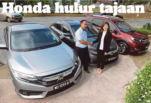  ??  ?? IRIS (kanan) menyerahka­n empat kereta Honda kepada wakil HMMTBGP 2017 Mohd Napi Ibrahim di Honda Malaysia Petaling Jaya, semalam.