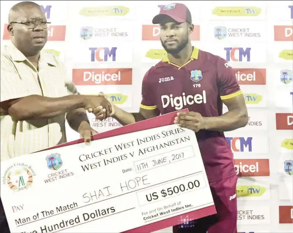  ??  ?? Shai Hope receives his Man-of-the-Match award for his unbeaten innings of 48.