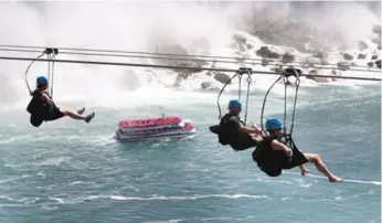  ??  ?? Thrill-seeking tourists to Niagara Falls can now fly high on the “MistRider” zip line attraction.