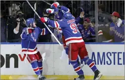  ?? ADAM HUNGER — THE ASSOCIATED
PRESS ?? New York Rangers left wing Artemi Panarin (10) reacts with teammates after scoring the game winning goal against the Pittsburgh Penguins.
