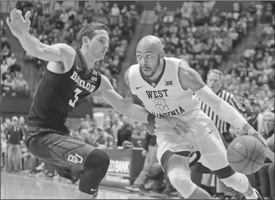  ?? Associated Press ?? Driving: West Virginia guard Jevon Carter (2) drives to the basket while being defended by Baylor guard Jake Lindsey (3) during the second half of their game Tuesday in Morgantown, W.Va.