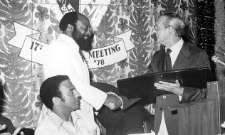  ?? FILE ?? Top – 1976: PLANS FOR TOURISM: Director of Tourism Adrian Robinson (at mike), announcing plans to develop the tourist industry. Others (from left) are George DeMercado, Ainsley Elliott and Winnie Risden.