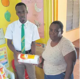  ?? CONTRIBUTE­D ?? Tajay Francis hands over one of the items his foundation donated to June Dobson, principal of Junior Leaders Daycare.