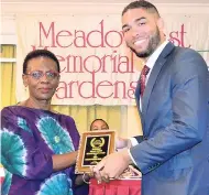  ??  ?? Scott Roman of Roman’s Funeral Home receiving a trophy from Carol Burgher, grief counsellor, for Business Quality.