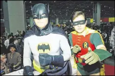  ?? AP 1989 ?? Actors Adam West (left) and Burt Ward, dressed as their characters Batman and Robin, pose for a photo at the “World of Wheels” custom car show in Chicago.