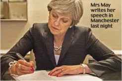  ??  ?? Mrs May writes her speech in Manchester last night