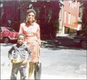  ?? COURTESY OF ERNIE SUGGS ?? Thelma Suggs, who usually opted for a short Afro, and her youngest son, Eric Suggs, in front of their Brooklyn apartment around 1974.