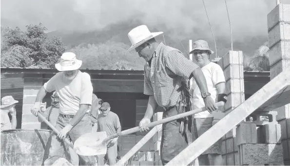  ?? [SUBMITTED] ?? Volunteers give the locals a hand building a school during Jeanne Amos’ last trip to Honduras. She’s planning another trip to the country in January to take part in a World Accord project.