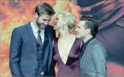  ?? Games: Mockingjay – Part 2
Hunger PICTURE: EPA ?? GOOD FRIENDS: Josh Hutcherson, Jennifer Lawrence and Australian actor Liam Hemsworth at the world premiere of
in Berlin.