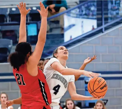  ?? SARAH PHIPPS/THE OKLAHOMAN ?? Edmond North’s Elle Papahronis goes to the basket as Westmoore’s Kyiah Prestridge defends during a game on Feb. 3 in Edmond.