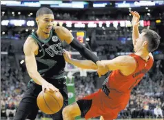  ?? Mary Schwalm ?? The Associated Press Celtics forward Jayson Tatum drives against Trail Blazers guard Pat Connaughto­n in the second half of Boston’s 97-96 win Sunday.