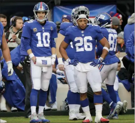  ?? FRANK FRANKLIN II - THE ASSOCIATED PRESS ?? New York Giants quarterbac­k Eli Manning (10) and Saquon Barkley (26) on the sidelines during the second half of an NFL football game against the Dallas Cowboys, Sunday, Dec. 30, 2018, in East Rutherford, N.J.