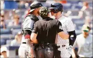  ?? Sarah Stier / Getty Images ?? Umpire Nick Mahrley attempts to separate the White Sox’s Yasmani Grandal and the Yankees’ Josh Donaldson during the fifth inning at Yankee Stadium on Saturday.