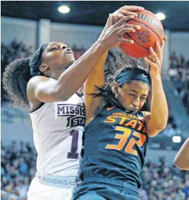  ?? [AP PHOTO] ?? Mississipp­i State center Teaira McCowan (15) battles Oklahoma State guard Loryn Goodwin (32) for a rebound during Monday’s round-two game in the NCAA women’s college basketball tournament in Starkville, Miss.