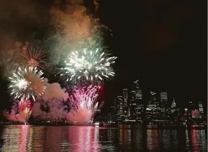  ?? Kathy Willens / Associated Press ?? A surprise fireworks display sponsored by Macy’s is held over the Hudson Yards area of Manhattan on Tuesday. Coronaviru­s concerns could change the way the Independen­ce Day holiday is celebrated this year.
