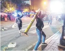  ??  ?? Protesters face off with police in Atlanta.