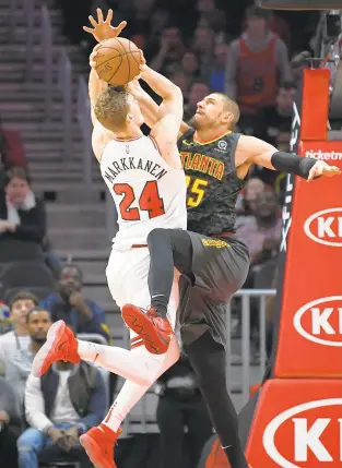  ?? JOHN AMIS/ASSOCIATED PRESS ?? Chicago Bulls forward Lauri Markkanen goes up to shoot with Atlanta Hawks center Alex Len defending during the second overtime Friday in Atlanta. Markkanen had 31 points and 17 rebounds.