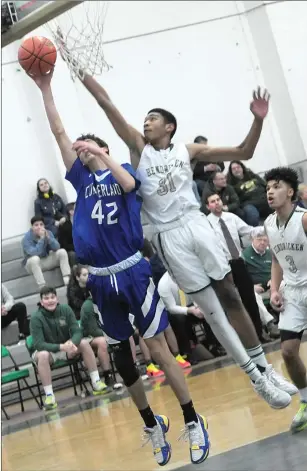  ?? Photo by Ernest A. Brown ?? Thanks to the steady play of freshman guard Colin Mories (40) and Seth Anderson (42) the No. 16 Cumberland boys basketball team upset No. 1 Hendricken in the Open tournament Thursday.