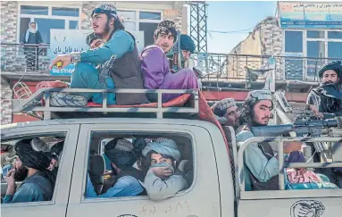  ?? BULENT KILIC AFP VIA GETTY IMAGES ?? Members of the Taliban drive along a road in Kabul on Thursday. Thomas Walkom writes that the practical position means a willingnes­s to talk to Afghanista­n’s de facto rulers — even though we disapprove of them.