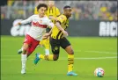  ?? ?? Borussia Dortmund’s Youssoufa Moukoko, right, challenges for the ball with
Stuttgart’s Enzo Millot during the German Bundesliga soccer match Oct. 22.