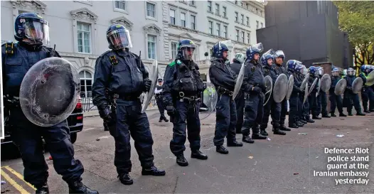  ?? ?? Defence: Riot police stand guard at the Iranian embassy yesterday