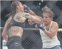  ?? JASON FRANSON THE CANADIAN PRESS FILE PHOTO ?? Cris Cyborg is punched by Canadian Felicia Spencer in 2019. Spencer’s on-again off-again title challenge against Amanda Nunes has been confirmed as UFC 250’s main event Saturday.