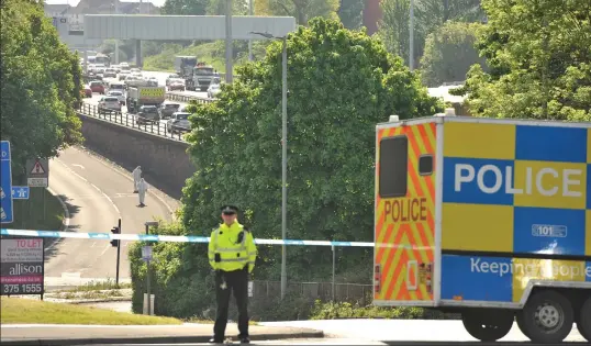  ??  ?? Police at the scene of the shooting, which closed a junction of the M8 and caused a man to be taken to hospital with facial injuries