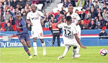  ??  ?? Paris Saint-Germain’s French forward Moussa Diaby (L) looks on as he scores his team’s fifth goal during the French L1 football match between Paris Saint-Germain (PSG) and Amiens at the Parc des Princes stadium in Paris on October 20, 2018. — AFP