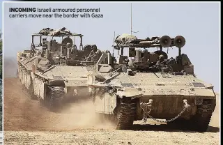  ?? ?? INCOMING Israeli armoured personnel carriers move near the border with Gaza