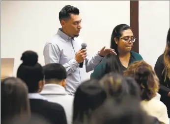  ?? NHAT V. MEYER — STAFF PHOTOGRAPH­ER ?? Juan Rocha, left, a senior in finance at San Jose State University, speaks during a presentati­on for Braven, a nonprofit organizati­on that helps teach students career-building skills.