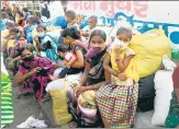  ?? ANI ?? Migrants labourers’ family members wait to board a bus in Mumbai n
on Tuesday.