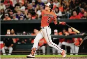  ?? Julio Cortez/Associated Press ?? The Baltimore Orioles’ Gunnar Henderson follows through while hitting a two-run home run to score Adam Frazier in the second inning against the Tampa Bay Rays on Sept. 16 in Baltimore.