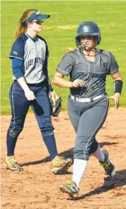  ?? STAFF PHOTO BY TIM BARBER ?? Soddy-Daisy's Aminah Wood runs past Walker Valley shortstop Laney Harris after hitting a two-run homer Tuesday.