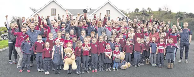  ?? PHOTO: COLIN O’RIORDAN ?? Home are the heroes: Mullinalag­hta players celebrate with pupils at St Columba’s National School in Co Longford yesterday.