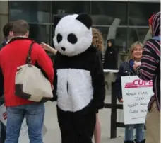  ?? DAVID RIDER/TORONTO STAR ?? CUPE Local 1600 members, including one dressed in a panda suit, gathered outside city hall before attending a Toronto Zoo board meeting Thursday.
