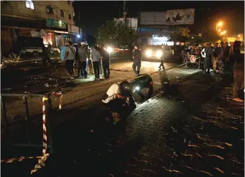  ?? — Reuters photo ?? Palestinia­ns check the scene following an explosion in Gaza City.