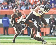  ?? KEN BLAZE/USA TODAY SPORTS ?? Ravens tight end Mark Andrews leaps over Browns free safety Damarious Randall during the first half at FirstEnerg­y Stadium.