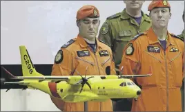  ?? CP Photo ?? Cpl. Chris Auger and Warrent Officer Aaron Bygrove looks at a model of the Airbus C295 at CFB Trenton in Trenton, Ont.