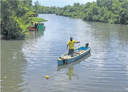  ?? Photo: Sheldon Chanel ?? Meli Kenawai fishing in the Laqere River using his net on his boat that is attached with a brand new 18 horsepower engine.